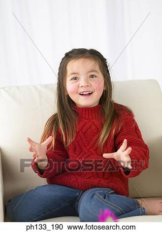 Young girl sitting on couch and smiling View Large Photo Image Stock Image - Young girl sitting on couch and smiling. Fotosearch