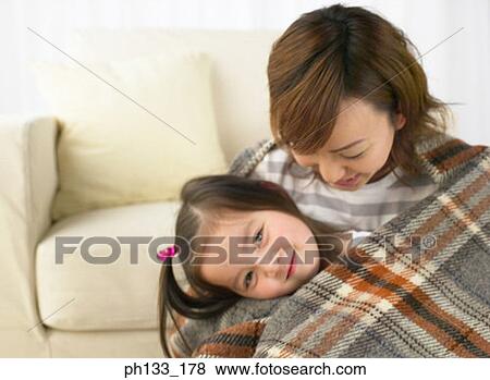 Stock Photo - Young woman holding her daughter. Fotosearch