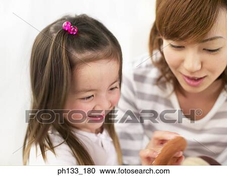 Young woman with her daughter View Large Photo Image Stock Image - Young woman with her daughter. Fotosearch