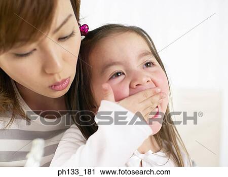 Stock Image - Young woman with her daughter. Fotosearch