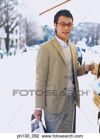 Asian Man buying coffee from a vendor View Large Photo Image Stock Image - Asian Man buying coffee from a vendor. Fotosearch
