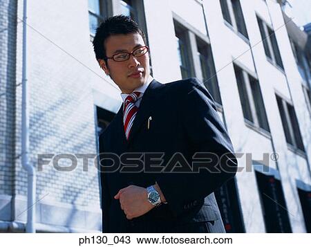 Asian Man looking down at the street View Large Photo Image Stock Image - Asian Man looking down at the street. Fotosearch