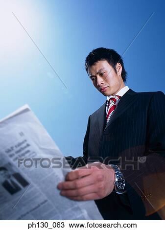 Asian Man reading the newspaper View Large Photo Image Stock Image - Asian Man reading the newspaper. Fotosearch