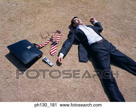 Asian Businessman lying flat on the ground View Large Photo Image Stock Image - Asian Businessman lying flat on the ground. Fotosearch