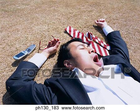 Asian Businessman lying flat on the ground View Large Photo Image Stock Image - Asian Businessman lying flat on the ground. Fotosearch
