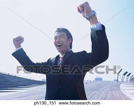 Asian Man flexing his arms in happiness View Large Photo Image Stock Image - Asian Man flexing his arms in happiness. Fotosearch
