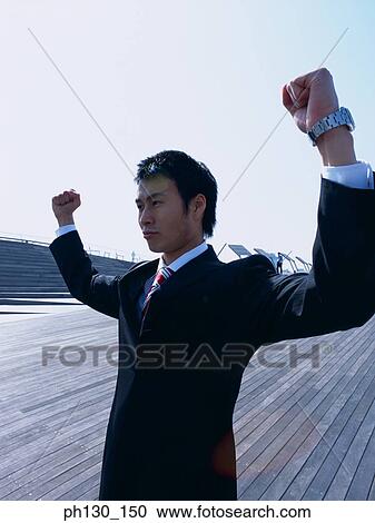 Asian Man flexing his arms View Large Photo Image Stock Image - Asian Man flexing his arms. Fotosearch