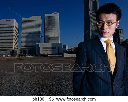 Asian Man standing in an empty parking lot View Large Photo Image Stock Photography - Asian Man standing in an empty parking lot. Fotosearch