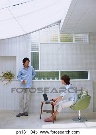 Stock Photography - Asian couple in conversation. Fotosearch