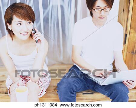 Asian couple sitting together View Large Photo Image Picture - Asian couple sitting together. Fotosearch