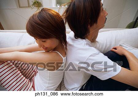 Stock Photograph - Asian couple sitting together. Fotosearch