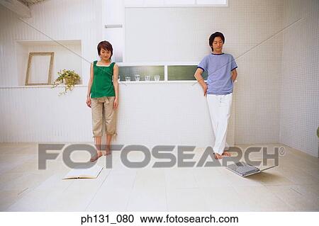 Asian couple standing in a room View Large Photo Image Stock Image - Asian couple standing in a room. Fotosearch