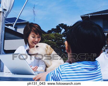 Asian family sitting out with their pet View Large Photo Image Stock Image - Asian family sitting out with their pet. Fotosearch