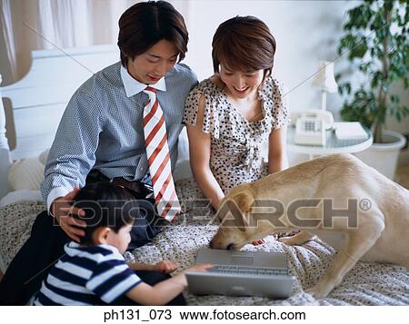 Asian family using a laptop View Large Photo Image Stock Image - Asian family using a laptop. Fotosearch