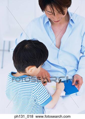 Asian father and son coloring in a notebook View Large Photo Image Stock Photo - Asian father and son coloring in a notebook. Fotosearch