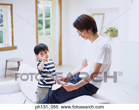 Asian father and son reading together View Large Photo Image Stock Photography - Asian father and son reading together. Fotosearch