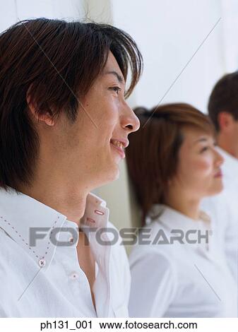 Asian Man and woman standing against a wall View Large Photo Image Stock Image - Asian Man and woman standing against a wall. Fotosearch