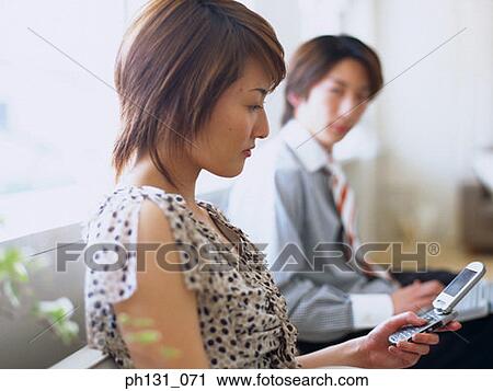 Asian woman using a cell phone View Large Photo Image Stock Image - Asian woman using a cell phone. Fotosearch