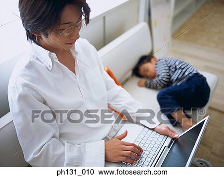 Father sitting on the couch with his sleeping son View Large Photo Image Stock Image - Father sitting on the couch with his sleeping son. Fotosearch