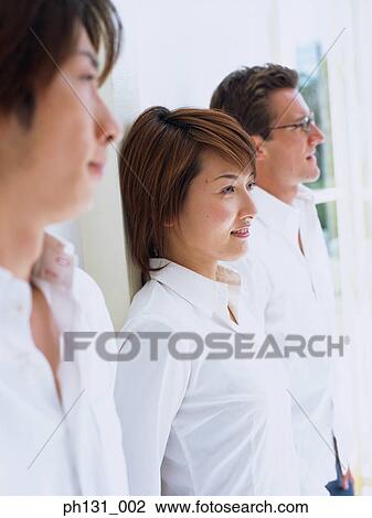 People standing against a wall View Large Photo Image Stock Image - People standing against a wall. Fotosearch