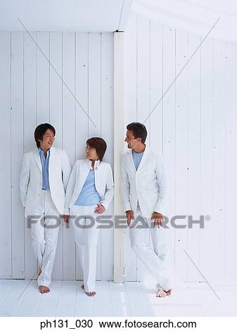 Stock Image - Two men and a woman talking. Fotosearch