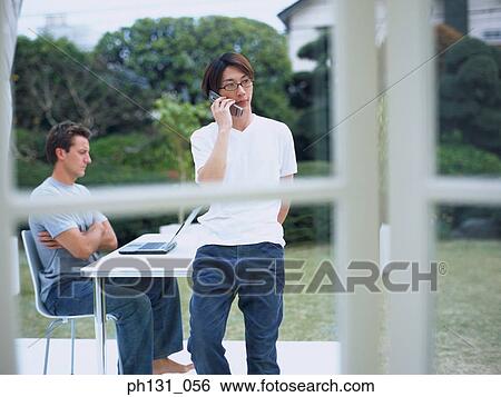 Two men sitting in the yard View Large Photo Image Stock Photograph - Two men sitting in the yard. Fotosearch