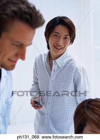 Stock Photo - Two men standing together. Fotosearch