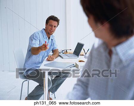 Stock Photography - Two men working together. Fotosearch