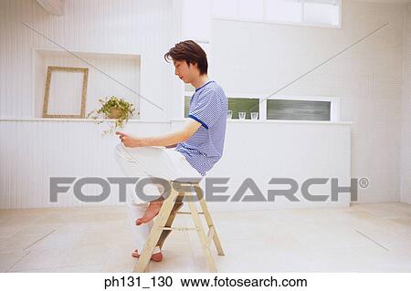 Stock Image - Asian man working on a laptop. Fotosearch