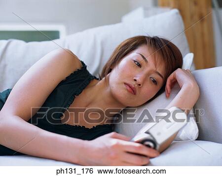 Stock Photograph - Asian woman using a cell phone. Fotosearch