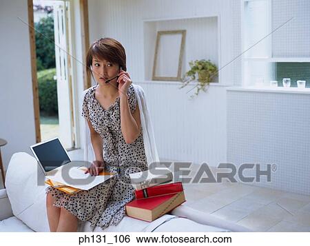 Asian woman wearing a headset View Large Photo Image Stock Photograph - Asian woman wearing a headset. Fotosearch