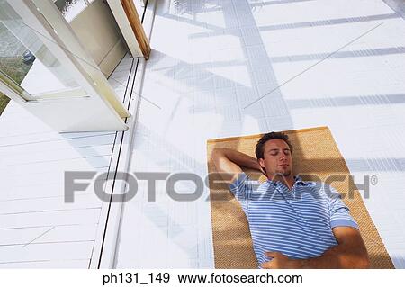 Caucasian man asleep on the floor View Large Photo Image Stock Photo - Caucasian man asleep on the floor. Fotosearch