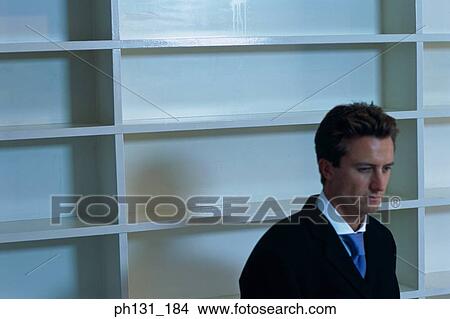 Caucasian man sitting in an empty office View Large Photo Image Picture - Caucasian man sitting in an empty office. Fotosearch