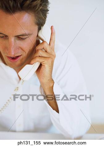 Stock Photography - Caucasian man talking on the phone. Fotosearch
