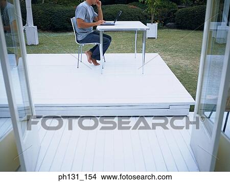 Picture - Man using a laptop. Fotosearch