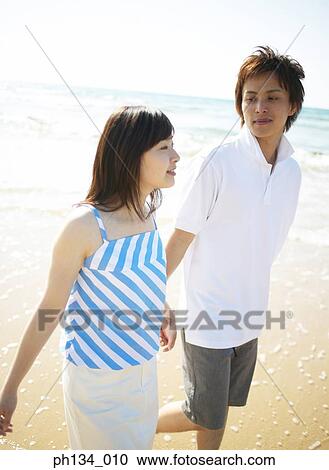 Stock Image - Young couple at the beach. Fotosearch