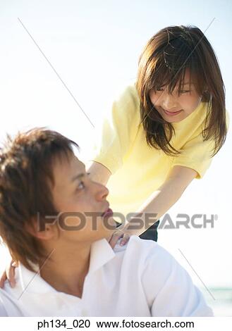 Young couple together at beach View Large Photo Image Stock Image - Young couple together at beach. Fotosearch