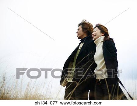 Young couple walking together View Large Photo Image Stock Photo - Young couple walking together. Fotosearch