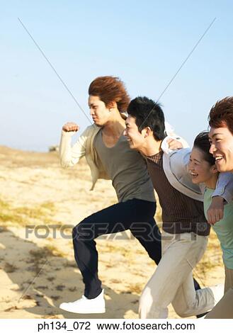 Young friends running together View Large Photo Image Stock Image - Young friends running together. Fotosearch