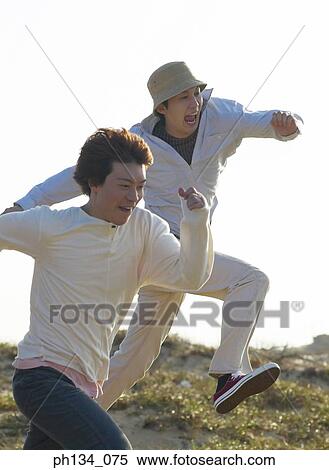 Young friends running together View Large Photo Image Stock Photography - Young friends running together. Fotosearch