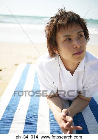 Young man at beach View Large Photo Image Picture - Young man at beach. Fotosearch