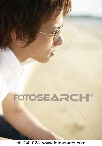 Young man wearing glasses View Large Photo Image Stock Photo - Young man wearing glasses. Fotosearch