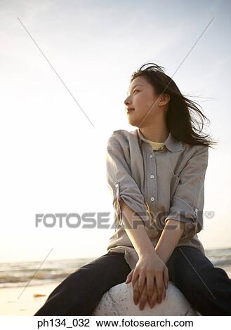 Young woman at beach View Large Photo Image Stock Image - Young woman at beach. Fotosearch