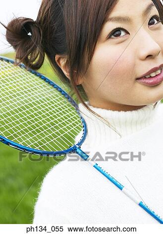Young woman holding racket View Large Photo Image Stock Photography - Young woman holding racket. Fotosearch