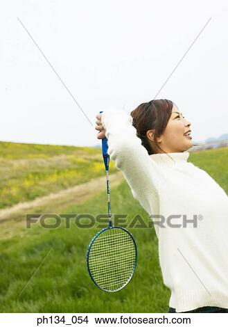 Young woman playing badminton View Large Photo Image Picture - Young woman playing badminton. Fotosearch