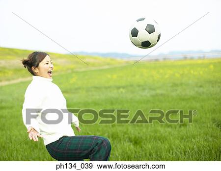 Young woman playing football View Large Photo Image Stock Photo - Young woman playing football. Fotosearch