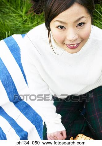 Young woman sitting and looking View Large Photo Image Stock Image - Young woman sitting and looking. Fotosearch