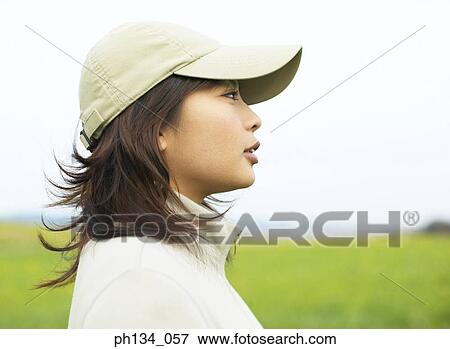 Stock Photo - Young woman wearing cap. Fotosearch