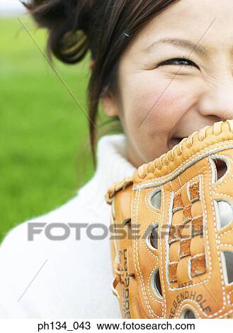Stock Image - Young woman with baseball mitt. Fotosearch