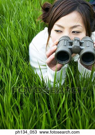 Young woman with binoculars View Large Photo Image Stock Image - Young woman with binoculars. Fotosearch
